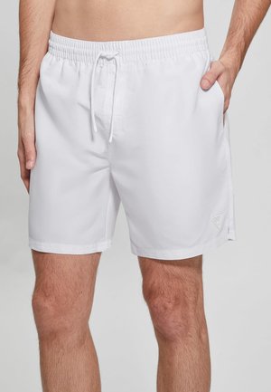 Pantaloni da bagno bianchi con fascia elastica in vita e cordoncino, tasche laterali e una piccola etichetta logata sull'orlo. Tessuto con una texture liscia.