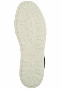 Suela de zapatilla de goma blanca con un patrón de dibujo que presenta múltiples formas hexagonales y rectangulares; logotipo "BLACKSTONE" grabado.