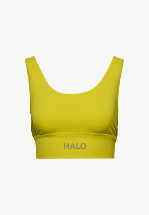 Żółty stanik sportowy wykonany z elastycznego materiału, z okrągłym dekoltem, szerokimi ramiączkami i logo HALO w kolorze szarym na środkowej taśmie.