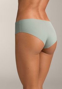 Lenjerie verde mentă fără cusături, cu textură netedă și design minimalist. Prezintă un croi cu talie medie și margini curate, oferind o potrivire confortabilă.