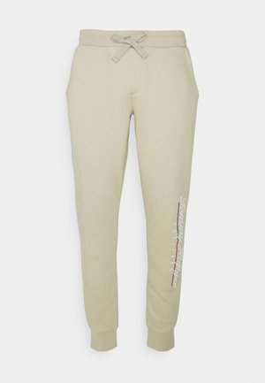 SCRIPT EMBROIDERY UNISEX - Tracksuit bottoms - desert tan