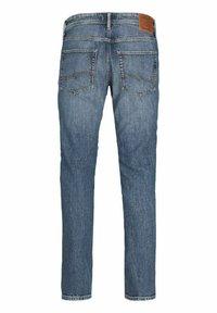 Jeans de denim azul slim-fit con una textura ligeramente desgastada, cinco bolsillos y un parche de cuero con marca en la cinturilla trasera.
