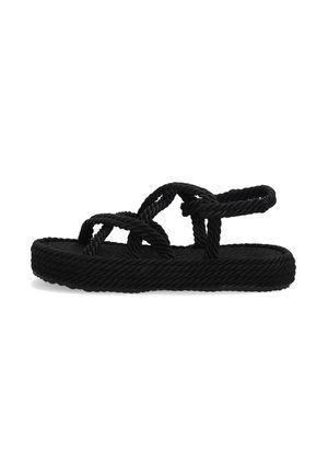 Black rope sandals feature a flat woven sole with twisted straps. Material appears lightweight with a textured surface. Adjustable ankle strap included.