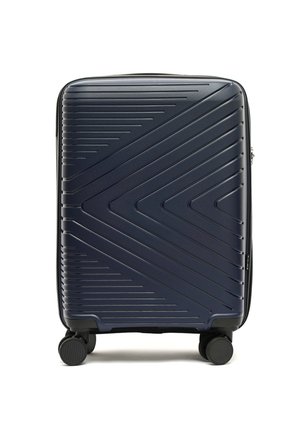 Navy hard-shell suitcase with diagonal ridges, rectangular shape, smooth texture, and four black wheels for easy mobility.