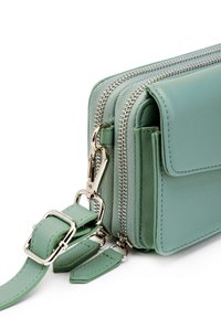 Green leather crossbody bag with a zip closure, silver-tone hardware, multiple compartments, and a detachable strap.