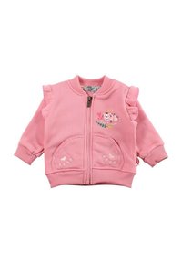 Veste zippée rose avec épaules à volants, motif tigre brodé et accents d'empreintes de pattes sur les poches. Tissu doux avec poignets côtelés.