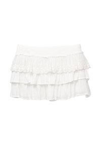 Jupe mini blanche à volants horizontaux. Fabriquée en tissu léger, elle présente un design texturé et un délicat bord en dentelle sur la couche supérieure.