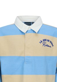 Polo con strisce orizzontali blu e beige, colletto bianco e testo ricamato in blu "LA JOIE DE VIVRE" e "Retour". Materiale in cotone.