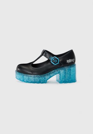Black Mary Jane shoe with a T-strap, blue geometric accent, and a clear chunky heel filled with glitter. Smooth leather upper with a matte finish.