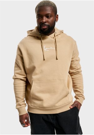 Hoodie beige avec une poche avant, capuche à cordon de serrage et logo brodé blanc. Matériau doux en mélange de coton avec poignets et ourlet côtelés.