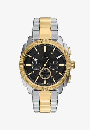 Męski zegarek Fossil na nadgarstek z czarną tarczą, złoto-srebrną metalową bransoletą, złotą fakturowaną lunetą oraz trzema subtarczami wskazującymi funkcje chronografu.