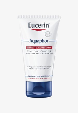 Weißer Behälter mit blauem Boden, beschriftet mit "Eucerin Aquaphor Protect & Repair." Enthält Informationen auf Deutsch zur Hautbehandlung bei trockener Haut.