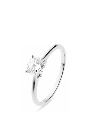 Silver solitaire ring with a single round sparkling diamond held by four prongs on a plain band.