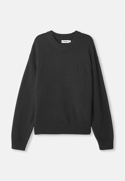 Black knitted sweater with a round neckline, ribbed cuffs and hem, featuring a subtle textured logo on the front left.