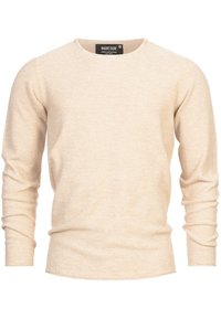Pull beige à manches longues avec un col rond. La texture semble tricotée ; le tissu est doux. Il présente une coupe droite avec des côtes discrètes aux poignets.