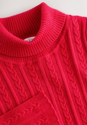 Maglione a collo alto in maglia rossa con dettagli a coste e motivo strutturato, realizzato in tessuto morbido e spesso con collo aderente.
