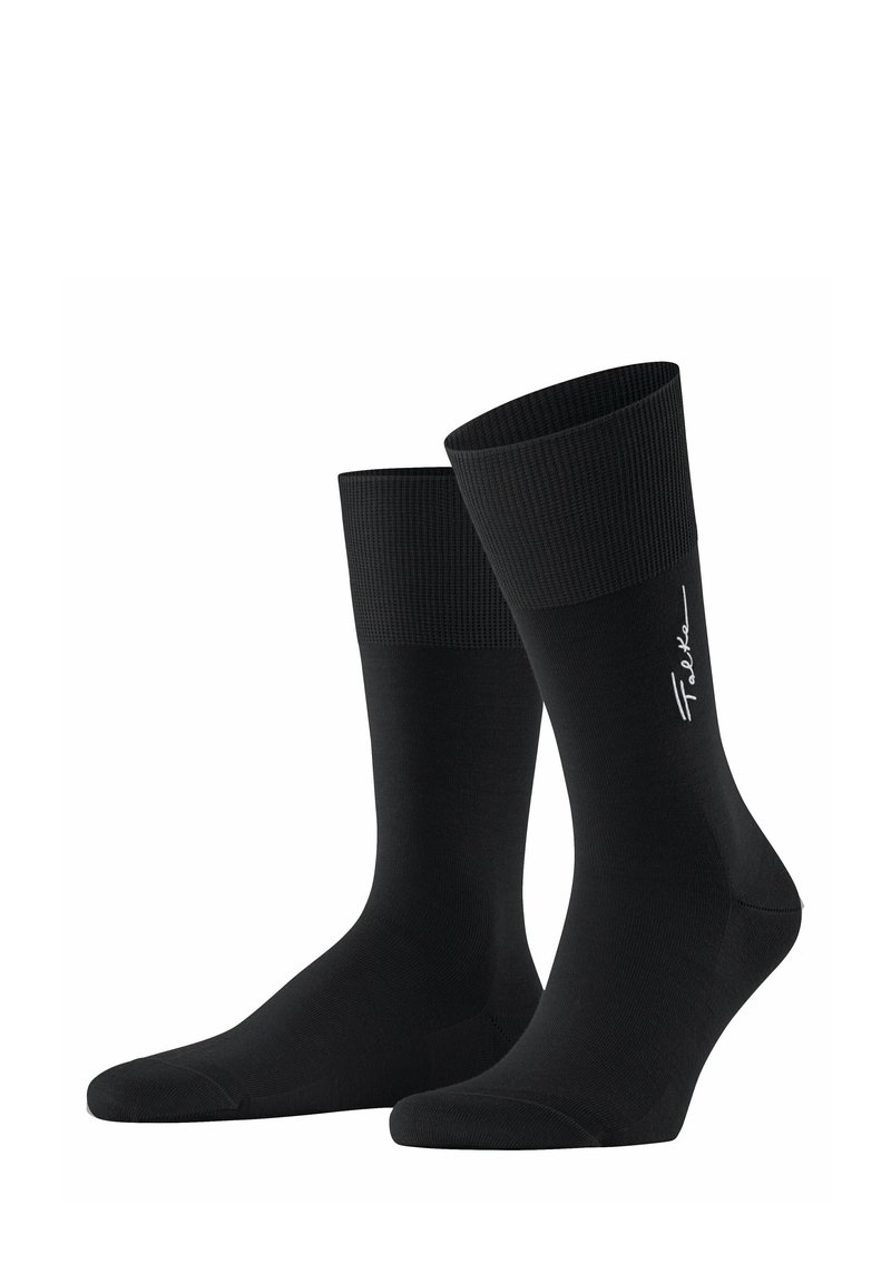 Un paio di calzini neri fino al polpaccio con polsini strutturati e logo in bianco sulla parte laterale, mostrati su uno sfondo bianco semplice.