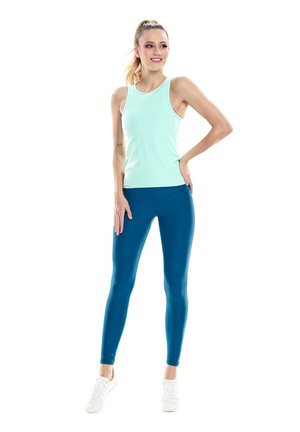 Light blue athletic tank top paired with teal leggings. Smooth, stretchy fabric with a fitted design, accented by white sneakers.