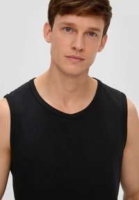 Black sleeveless t-shirt with a round neckline, made of soft fabric. Features a smooth texture and minimal stitching detail at the edges.