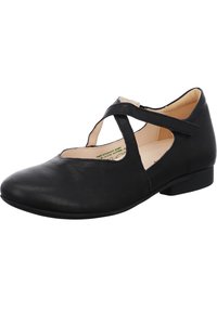 Bailarinas de cuero negro con punta redonda, diseño de laterales recortados y una delgada correa entrecruzada. Tacón bajo y textura suave.