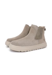 Stivaletti alla caviglia in suede beige con pannelli laterali elasticizzati e suola chunky color crema. Presentano una superficie texture e una linguetta sul tallone.