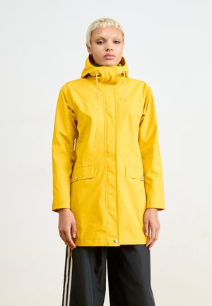 Yellow waterproof rain jacket with a hood, front zip closure, two front pockets, and drawstring. Smooth texture and mid-length design.