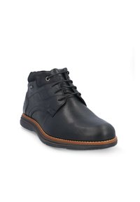 Botas de tobillo de cuero negro con acabado suave, punta redonda y diseño de cordones. Presenta una suela de goma marrón y detalles de costura sutiles.