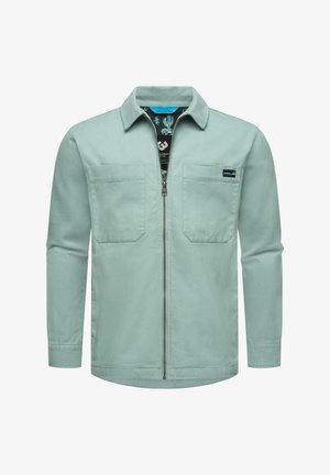 Mėtų žalios spalvos švarkas su ilgomis rankovėmis, dviem krūtinės kišenėmis ir priekiniais užtrauktukais. Jame yra raštuotas vidinis pamušalas ir klasikinis apykaklė.