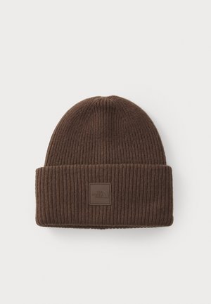 Brown ribbed knit beanie with folded cuff and a square patch logo on cuff reading "The North Face."