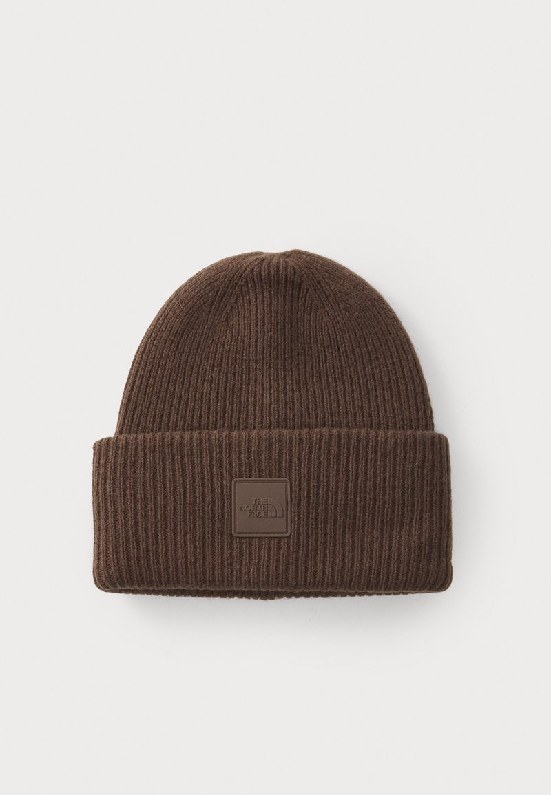 Bruine geribbelde gebreide muts met omgeslagen rand en een vierkante logopatch op de rand met de tekst "The North Face."