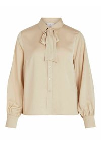 Blouse beige à manches longues avec boutons sur le devant, un nœud papillon au col et des poignets froncés.