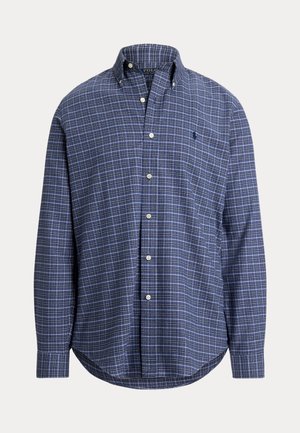 Camisa de hombre de manga larga con botones en color marino con un patrón a cuadros. Fabricada con tela escocesa, cuenta con un cuello clásico y un bolsillo en el pecho.