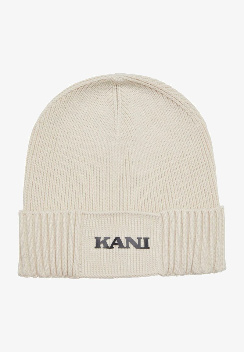 Cream knitted beanie hat with a ribbed cuff and embroidered black "KANI" logo on the front. Soft texture and tapered design.