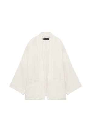 Jachetă albă texturată cu fron deschis, mâneci largi și două buzunare frontale, design casual și larg.
