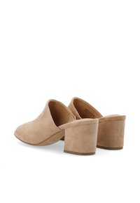 Mule in suede beige con punta chiusa e tallone aperto. Design con tacco a blocco robusto, caratterizzato da una texture liscia e uno stile minimalista.