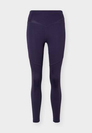 Dámske legíny tmavomodrej farby s vysokým pásom, s prešívanými panelmi na stehnách, priliehavé a dĺžkou po členky, bezšvový predný pás.