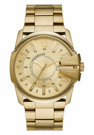 Guldtonet Diesel armbåndsur med metalrem, rund urskive der viser timer, minutter, sekunder, dato vindue, og tekst om vandmodstand.