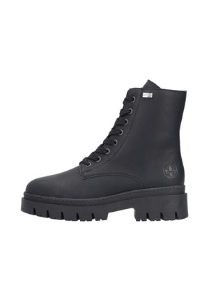 Black leather ankle boot with lace-up design, chunky rubber sole, and logo detail on the side. Smooth texture and cylindrical shape.