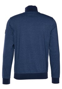 Felpa a maniche lunghe blu navy con colletto alto, polsini e orlo a coste. Tessuto morbido con un leggero motivo melange. Nessun marchio visibile.