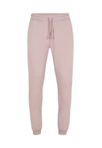 Pantaloni della tuta rosa realizzati in tessuto morbido, con vita regolabile tramite cordino, gambe affusolate e un logo discreto sulla parte frontale.