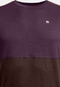 Short-sleeve T-shirt in dark purple and brown color block design, made of textured fabric with a round neckline and small logo detail.