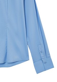 Light blue, long-sleeve shirt featuring a smooth texture, buttoned cuffs, and a straight hem with side slits for added movement.