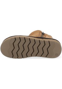 Semelle de botte en cuir brun avec un motif zigzag texturé et un bout arrondi. Dotée d'une fermeture éclair sur le côté pour un enfilage facile et d'une semelle intérieure rembourrée.