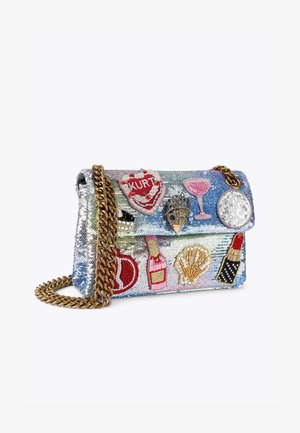 Borsa a tracolla con paillettes e catena dorata, decorata con vari patch ricamati, tra cui bevande e cosmetici, su uno sfondo iridescente.