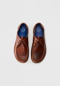 Pair of brown leather casual lace-up shoes with blue insoles on a plain white background, viewed from above.