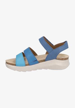 Blue sandal featuring multiple straps in varying shades, a textured cork footbed, and a white wedge sole for comfort and support.