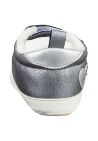 Back view of silver and white baby shoe with soft white fleece lining and heart-shaped detail on the side.