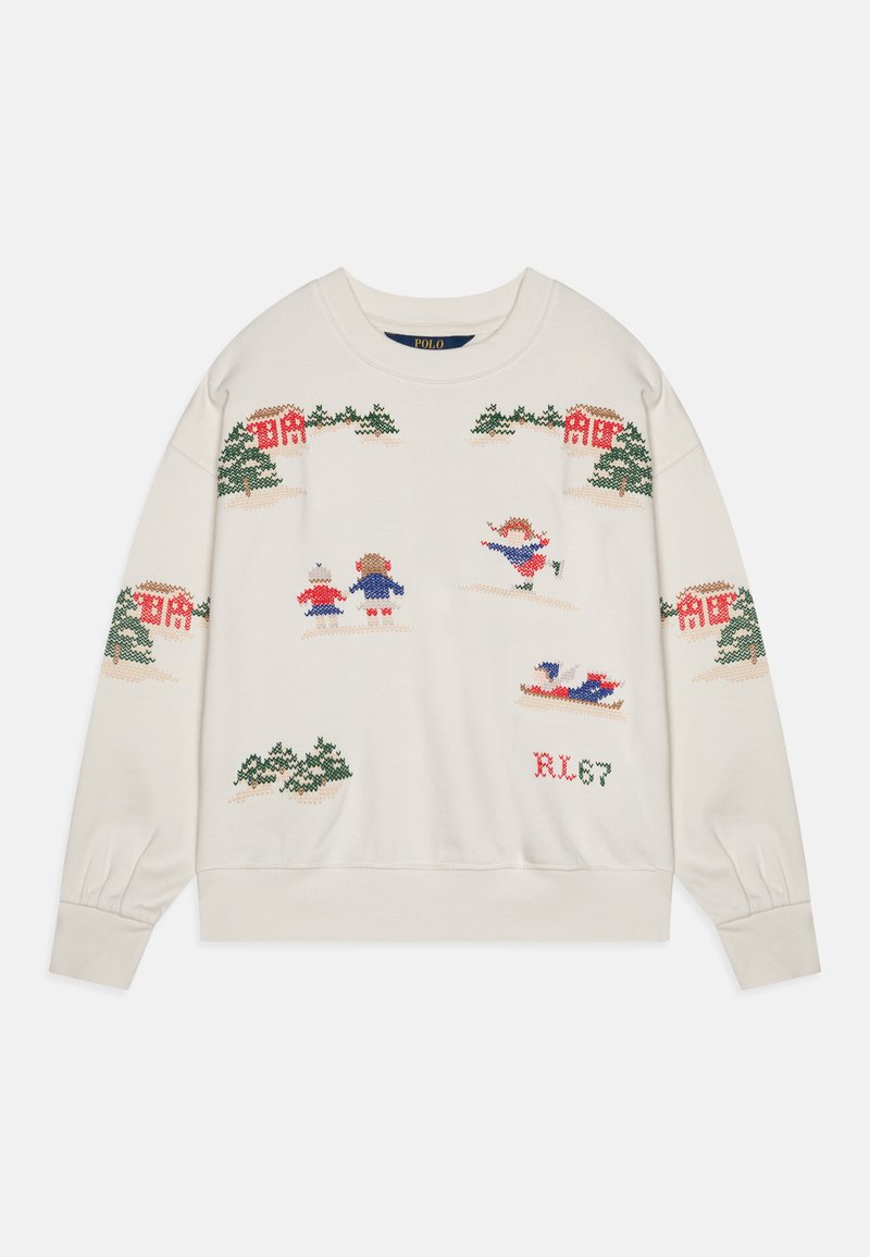 Adīta krējuma krāsas džemperis ar ziemas ainavu, kurā redzami koki, mājas un figūras krāsainos tērpos. Ribu piedurknes un apakšmalas pievieno papildu detaļas.