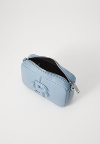 Pochette in pelle azzurro chiaro con finitura testurizzata, dotata di chiusura con zip e dettaglio del logo impresso sul davanti. Forma rettangolare compatta.