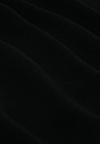 Black fabric with a smooth texture, featuring soft, flowing folds and subtle sheen, suitable for various applications.